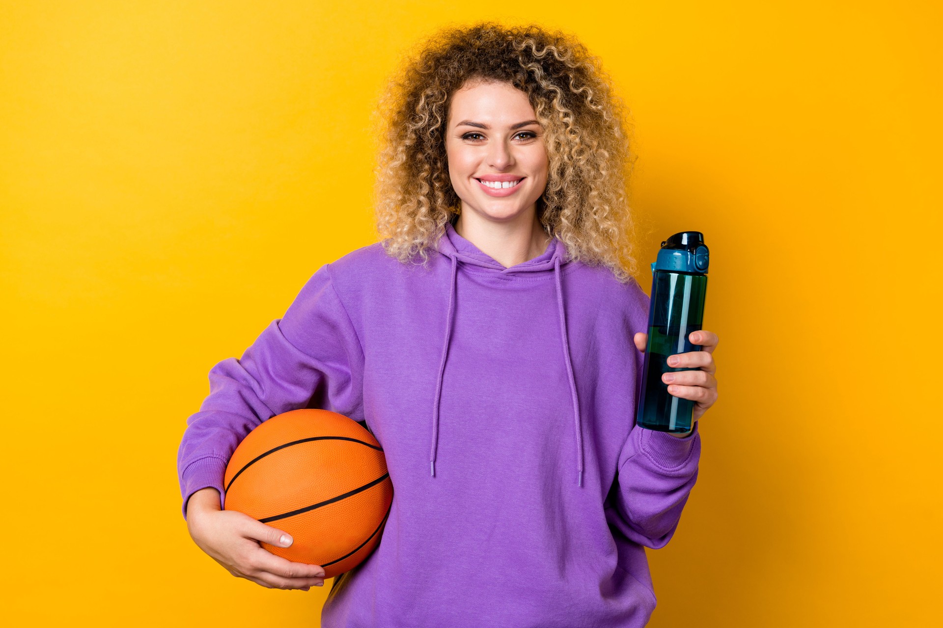 Photo of young pretty girl sportive hold water drink fresh workout hold ball isolated over yellow color background